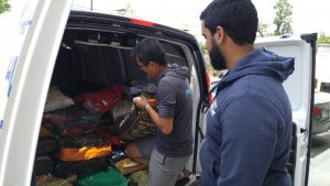 Chris and Lei unpack the donated cat food